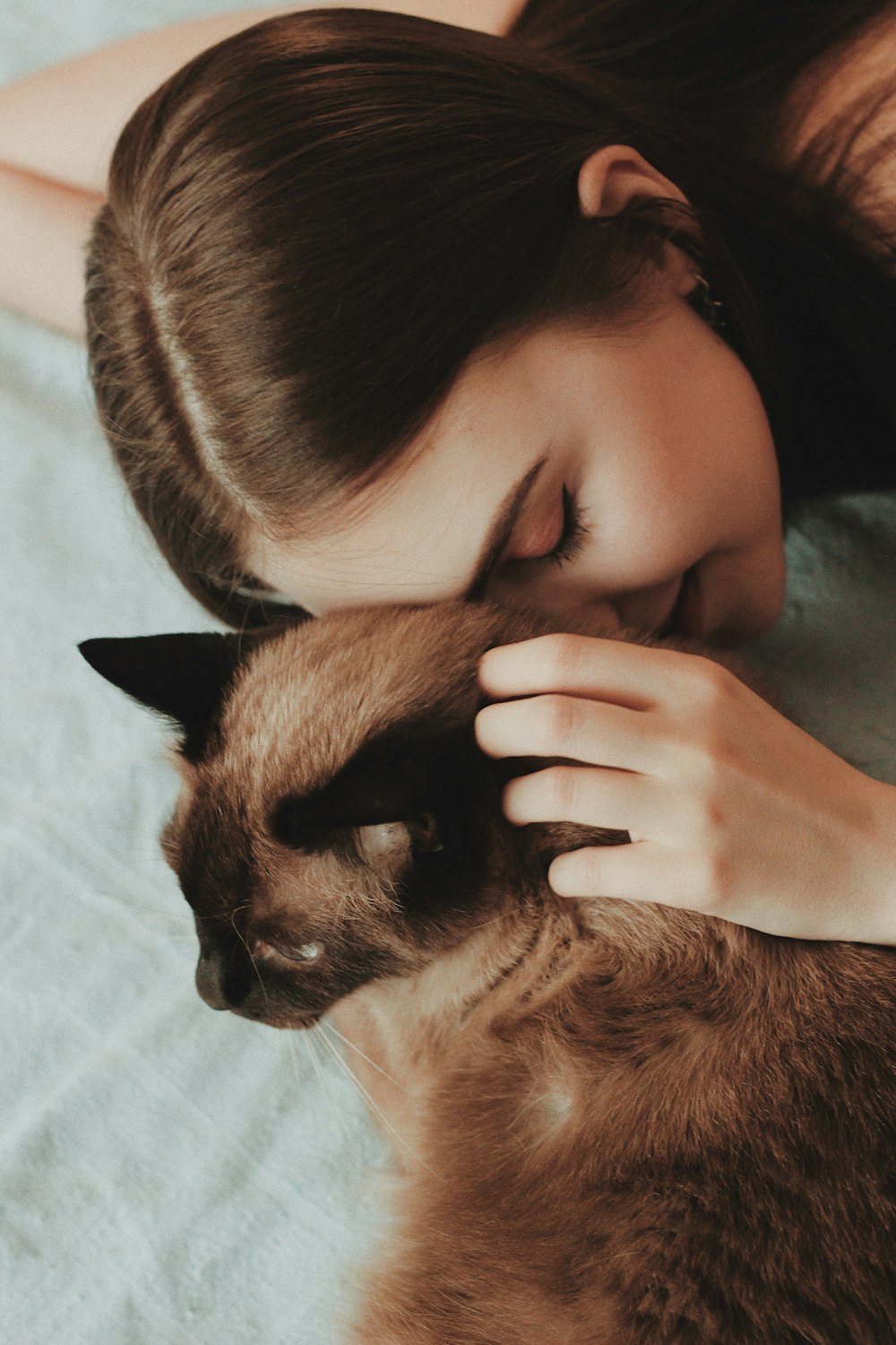 woman touching cat