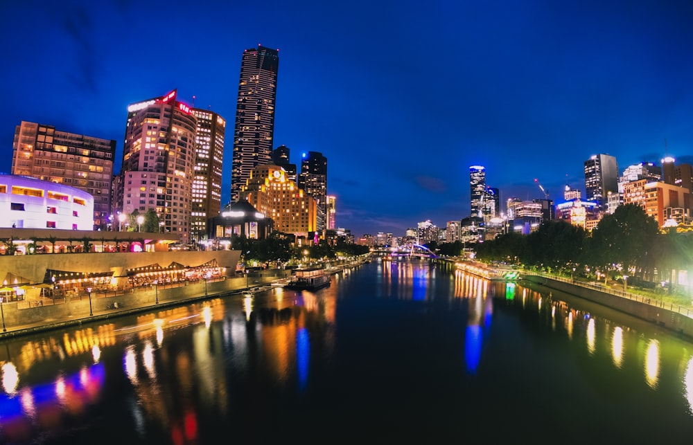 calm body of water in between buildings during nighttime