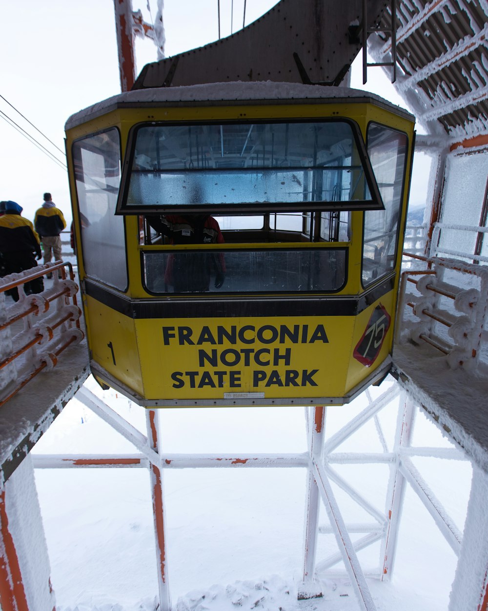 man inside cable cart near people