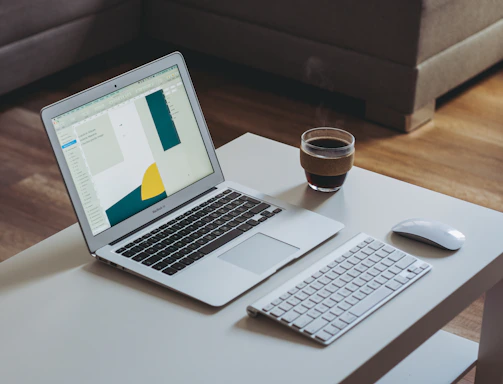 A sleek, modern workspace with a laptop, notebook, and a cup of coffee, symbolizing open communication.