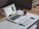 A professional workspace with a laptop and coffee on a wooden desk.