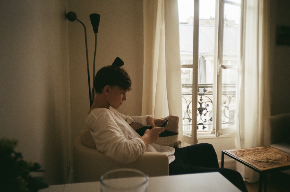 boy sitting on sofa chair