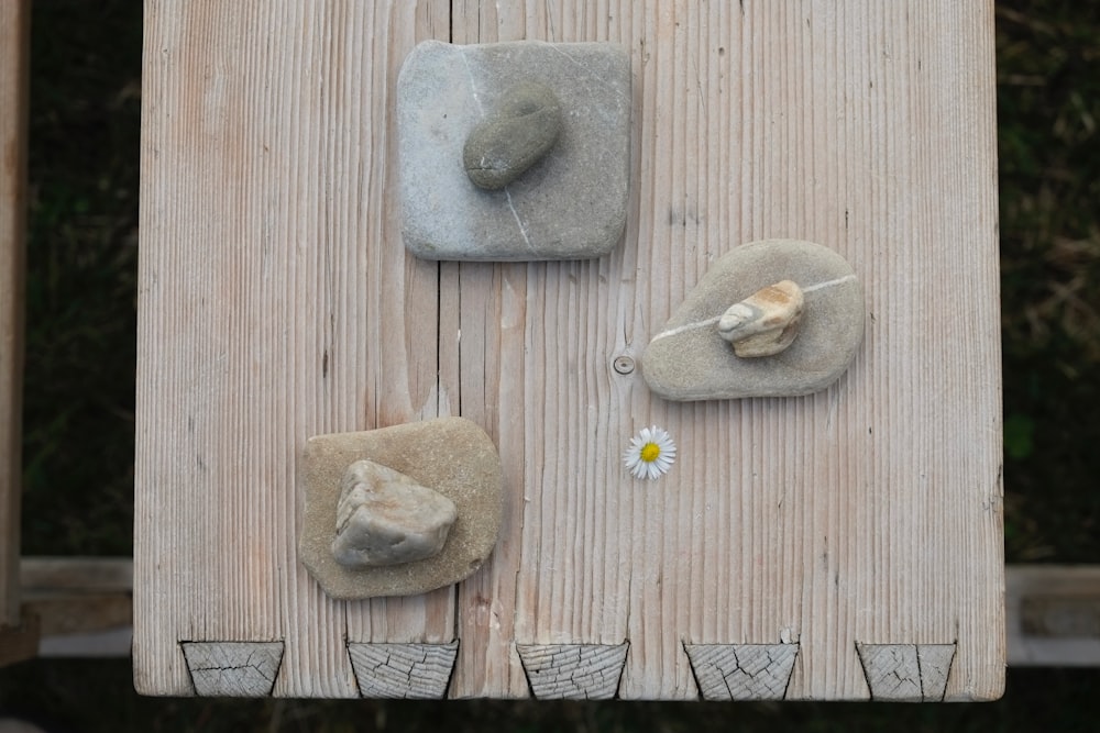 three gray stones on beige board panel