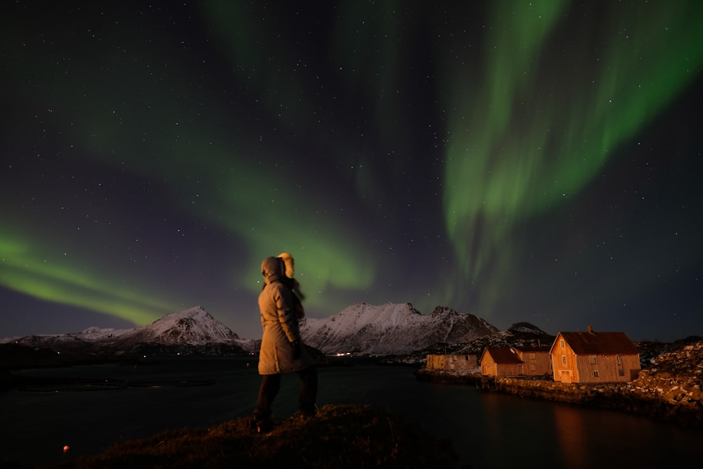 woman standing in front of aurora burial-es