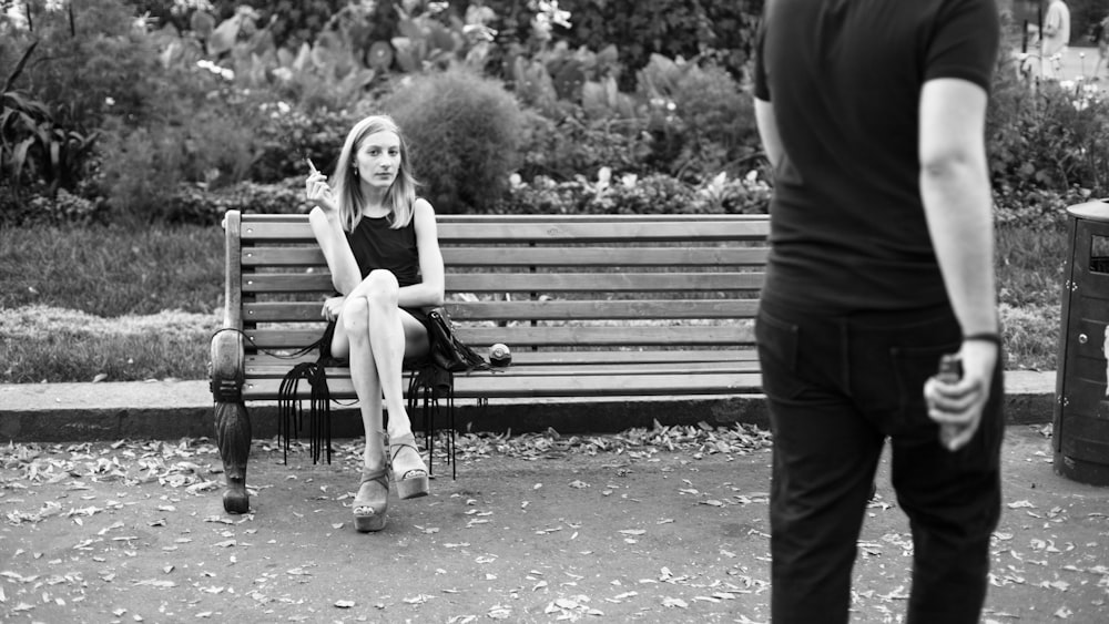 grayscale photography of woman sitting near man