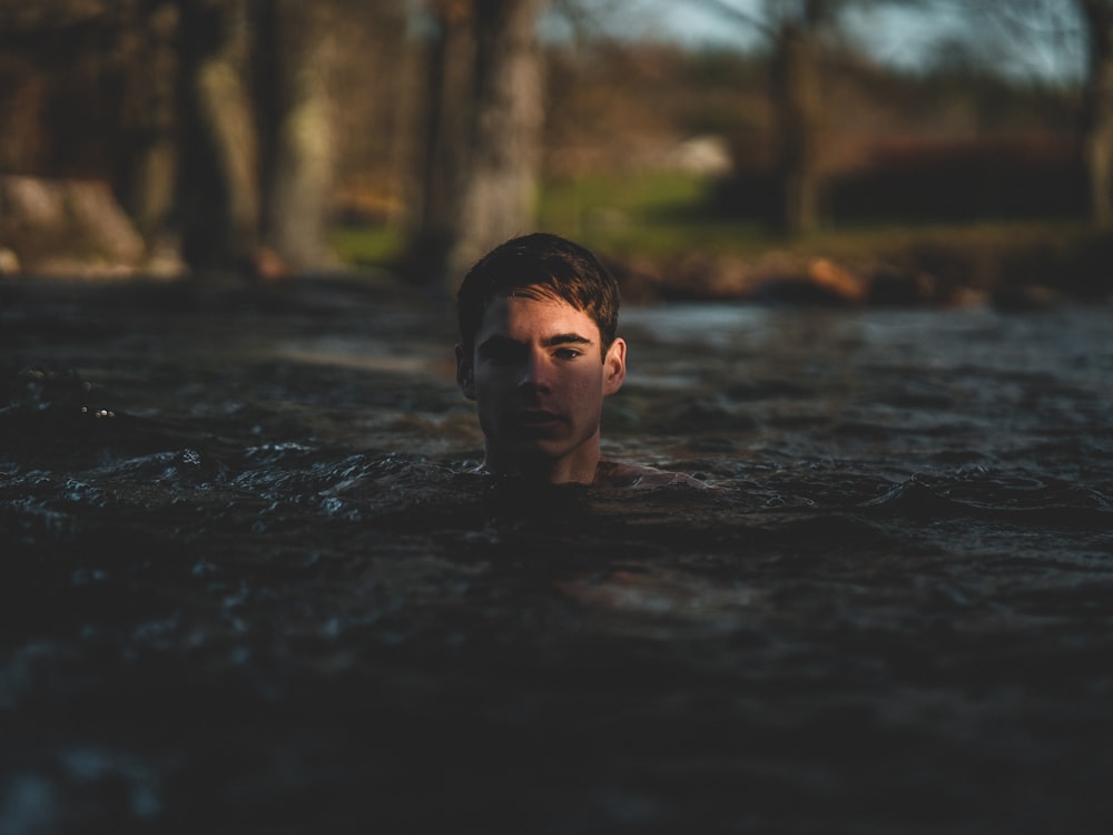 grayscale photography of man swimming