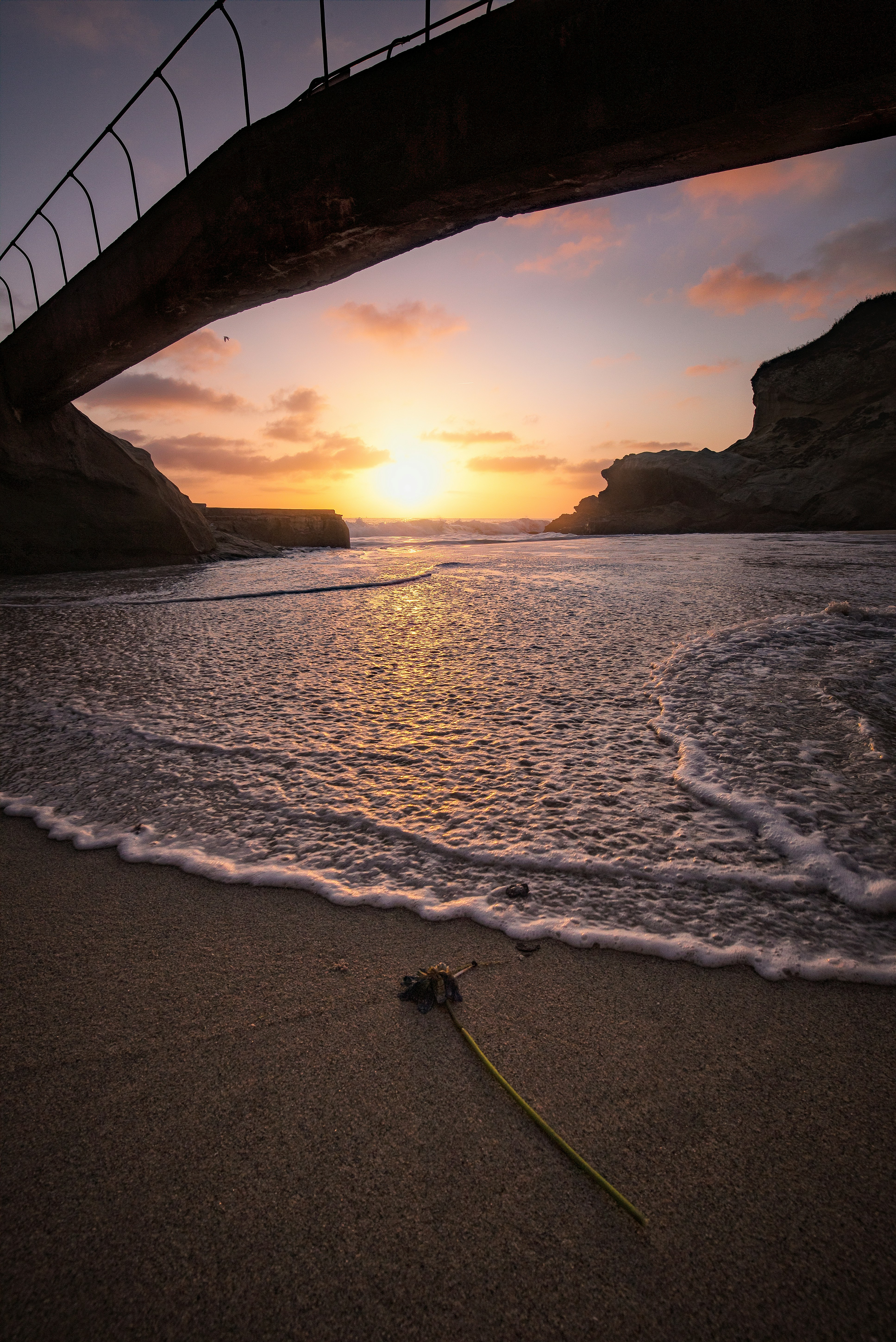 silhouette photo of bridge near sea