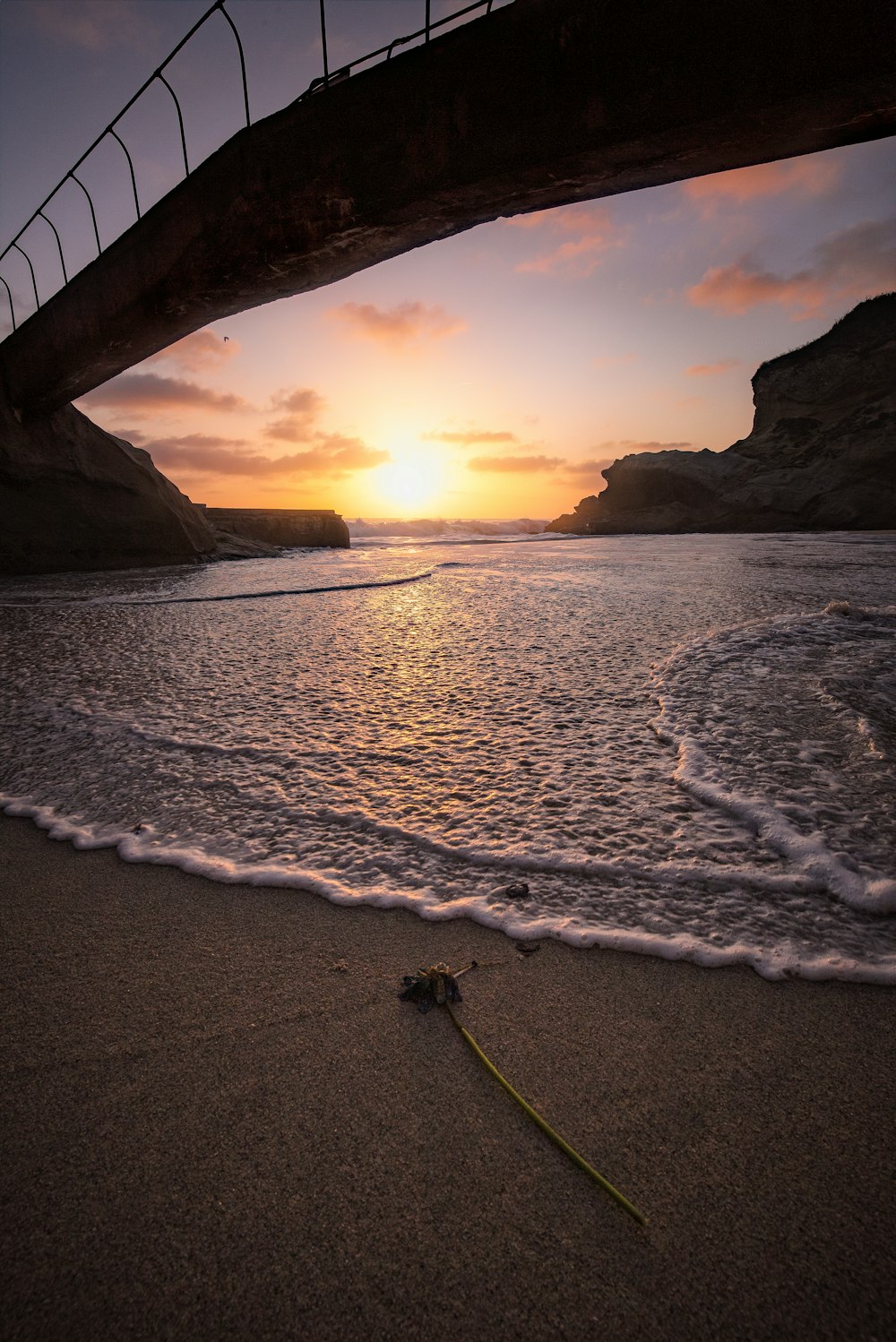 silhouette photo of bridge near sea