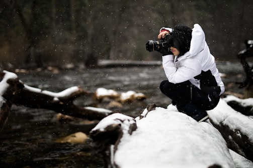 person holding camera on snow-covered surface