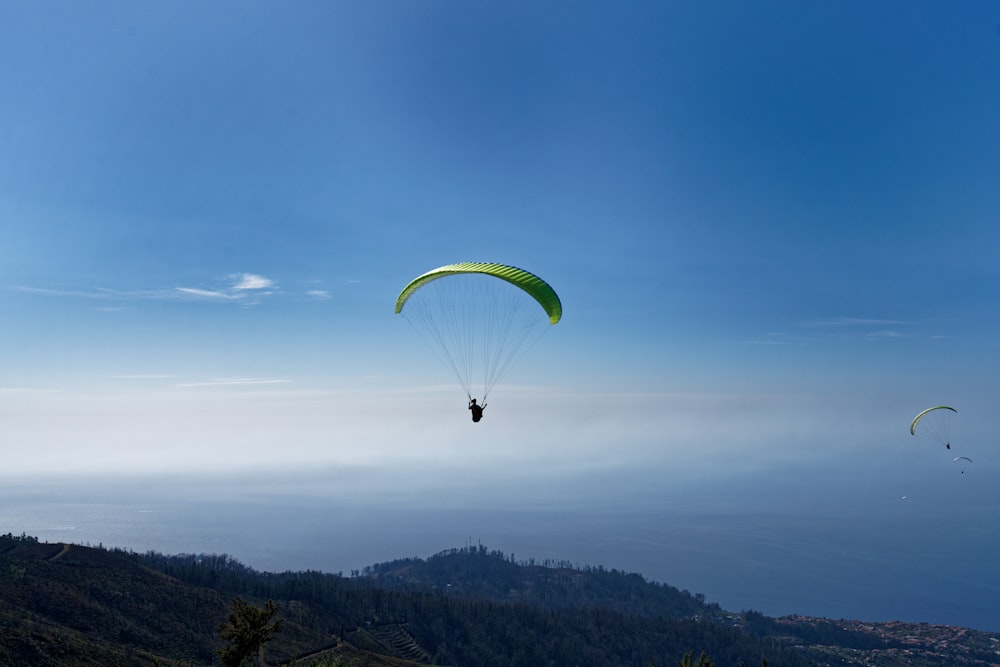 person paragliding over mountain during daytime