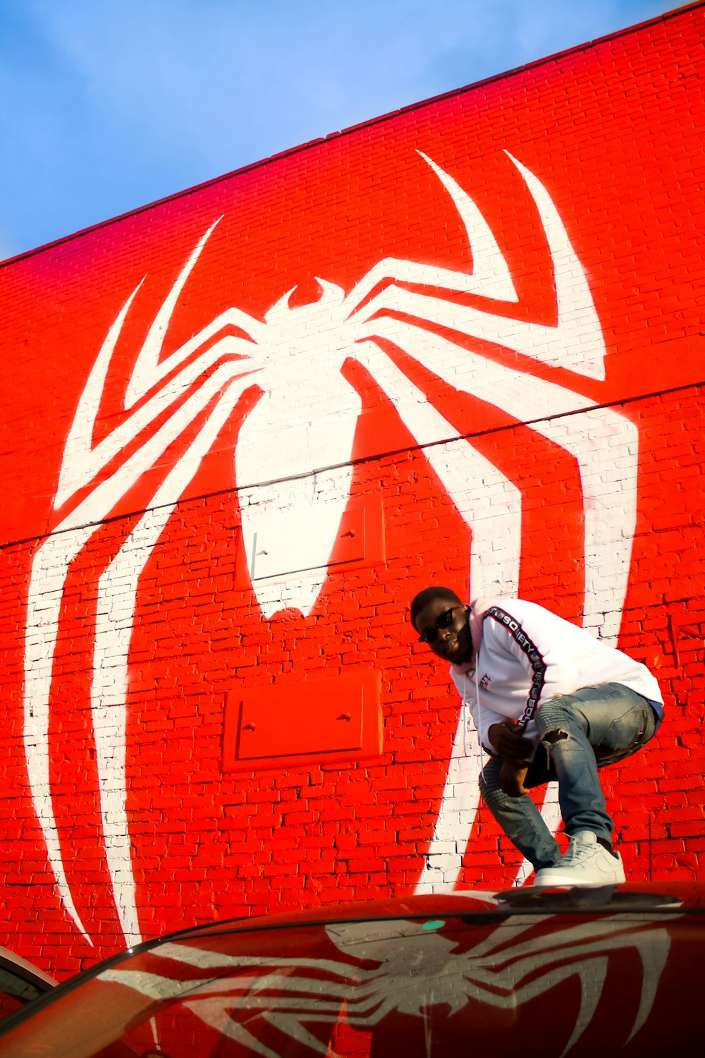 man standing in front of Spider-Man wall