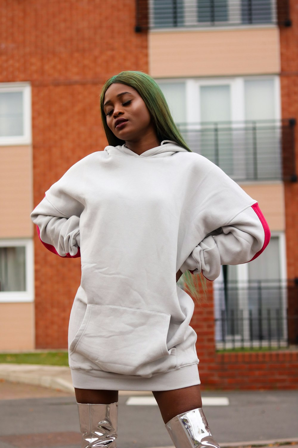 woman in white pullover hoodie putting two hands on waist