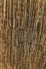 Close-up of brushed gold lines on deep bordeaux wine-red textured surface.