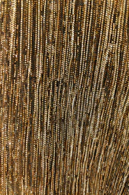 Close-up of brushed gold lines on deep bordeaux wine-red textured surface.