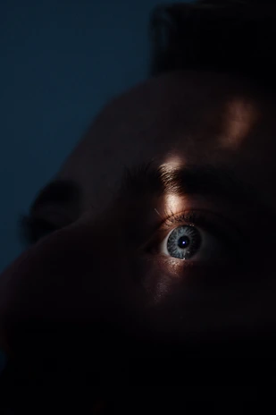Close-up of a sleek biometric eye scanner glowing softly against a dark background.