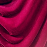 Rich, velvety fabric with deep folds and a smooth texture, creating an elegant and luxurious appearance.