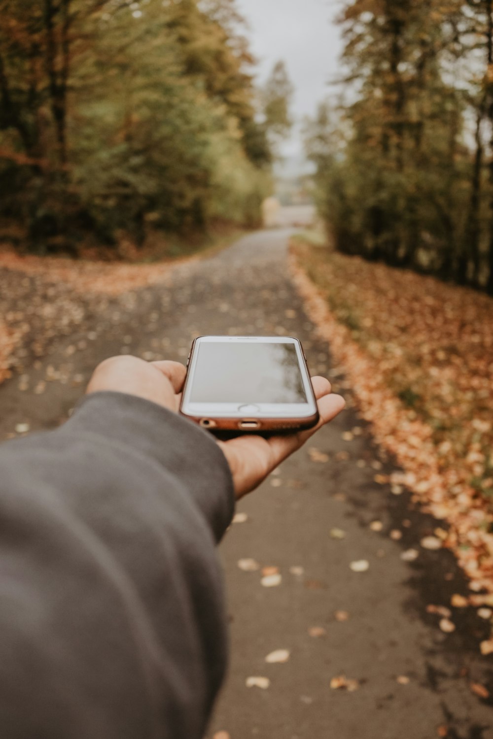 selective focus photography of person holding iPhone 6