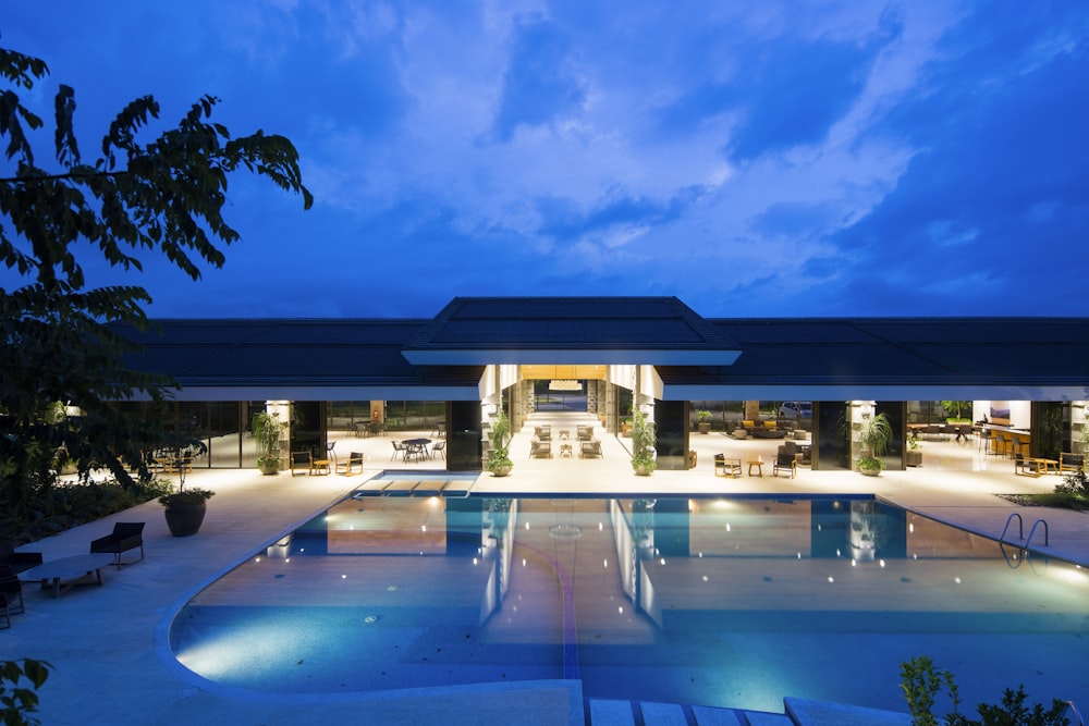 blue body of water in front of building near trees during nighttime