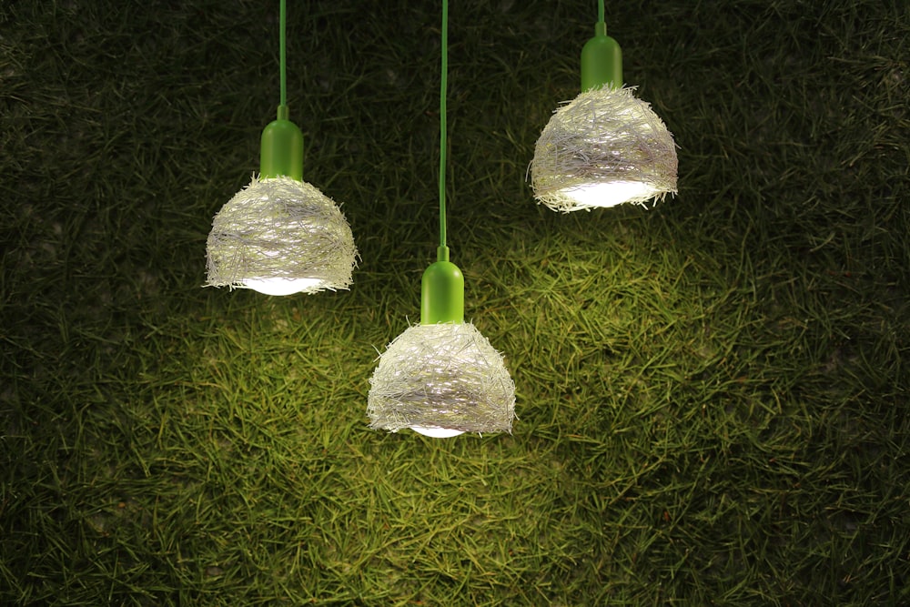 three green-and-white pendant lamps