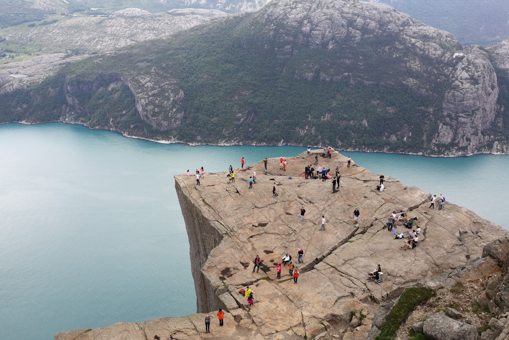 people standing on rock formation during daytime