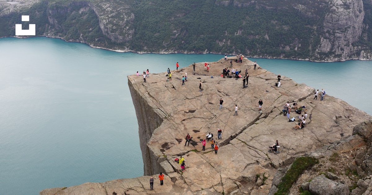 People standing on rock formation during daytime photo – Free Land ...