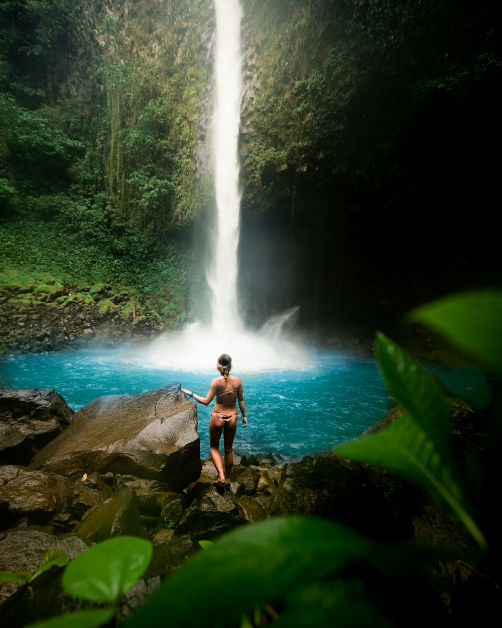 woman standing near waterfalls