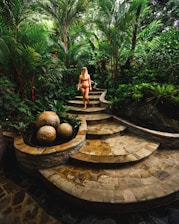 woman in bikini walking down the stairs at the garden