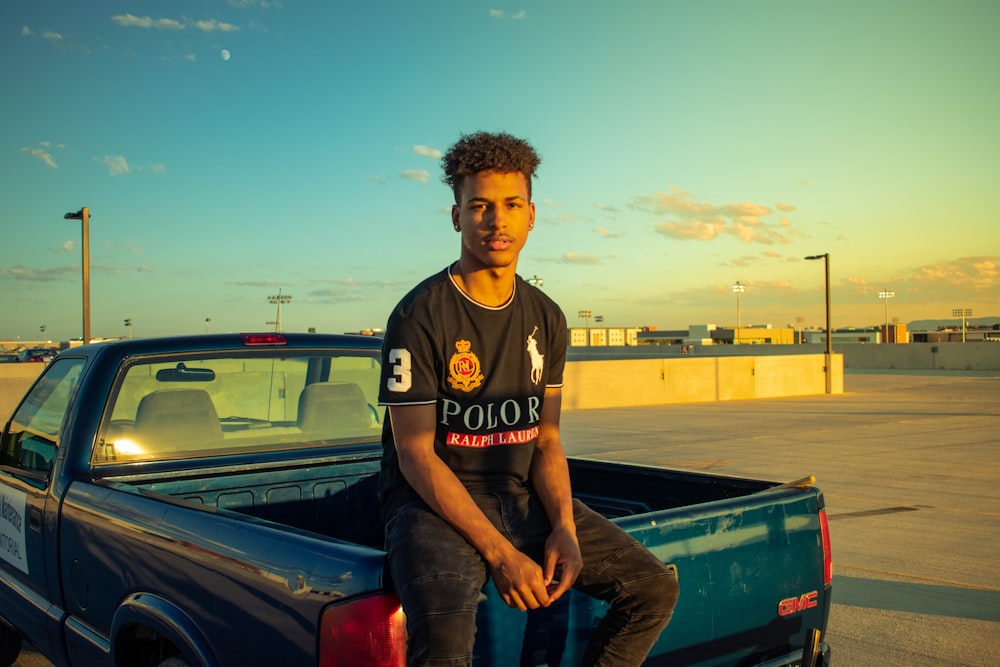 man sitting on pickup truck