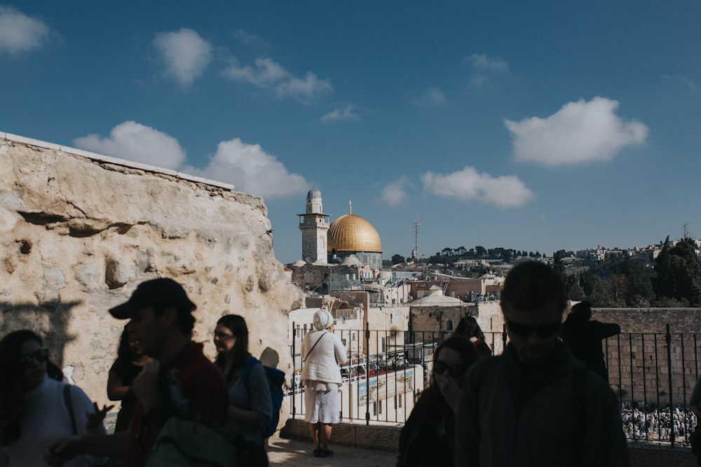 people walking around building near mosque