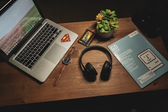 MacBook Pro beside cordless headphones