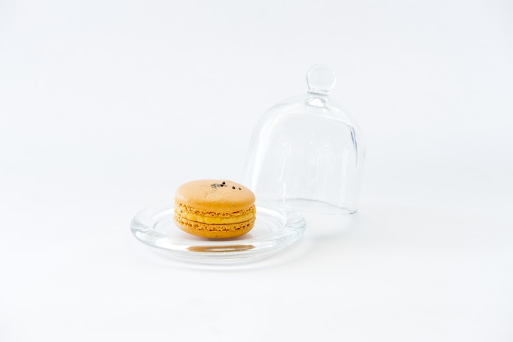 a glass bottle and a plate with a cookie on it