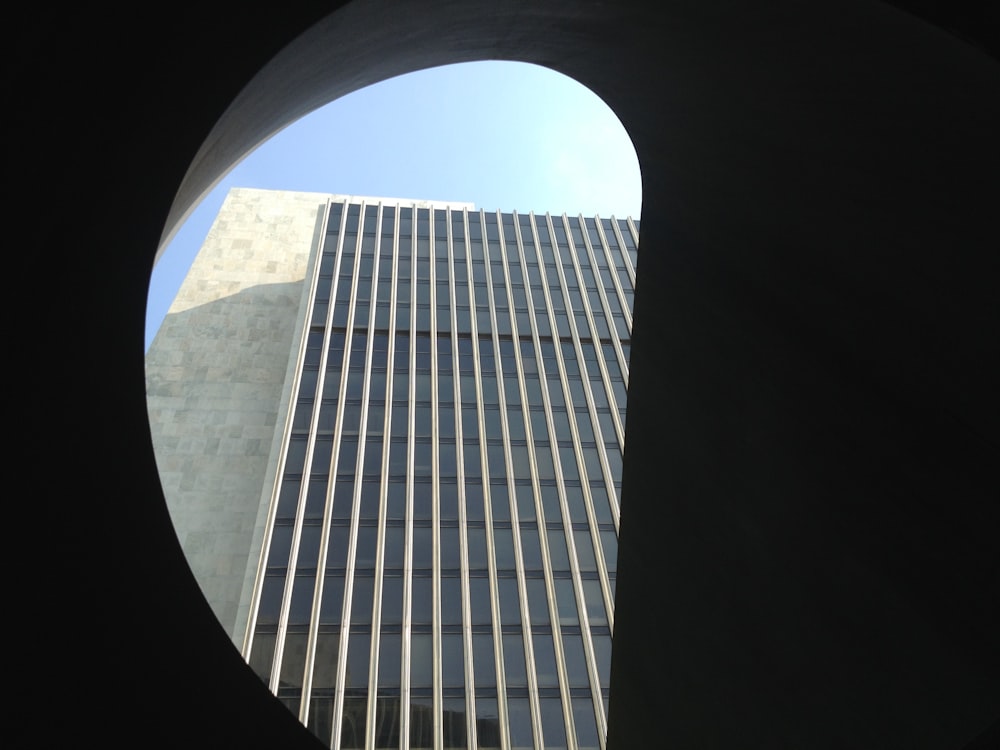a view of a tall building through a circular window