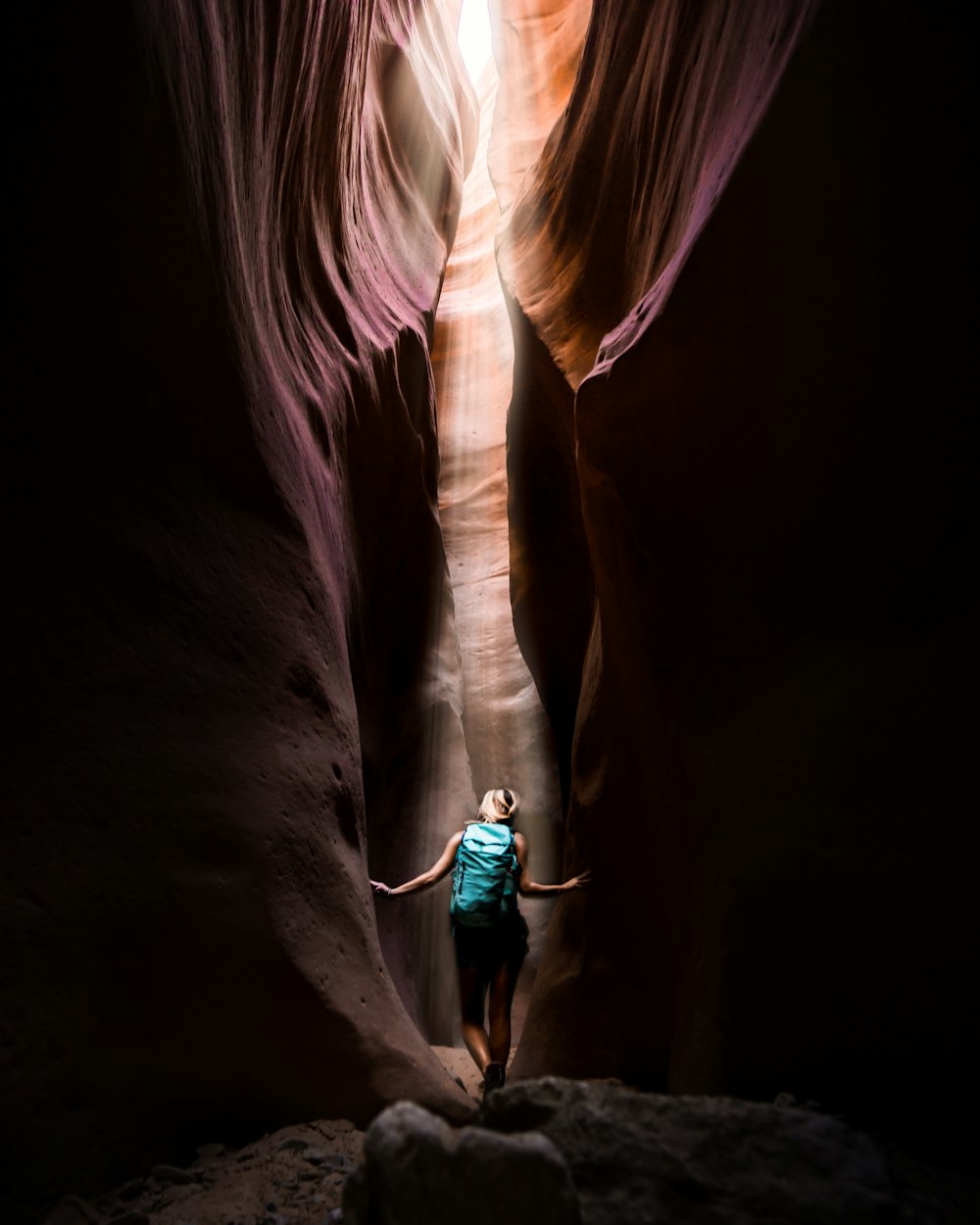woman standing inside Antelope Canyon during golden hour