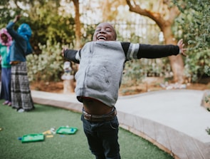 Local children playing joyfully in the green fields of San Pablo de Borbur