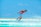 man in red tank top doing water sports during daytime