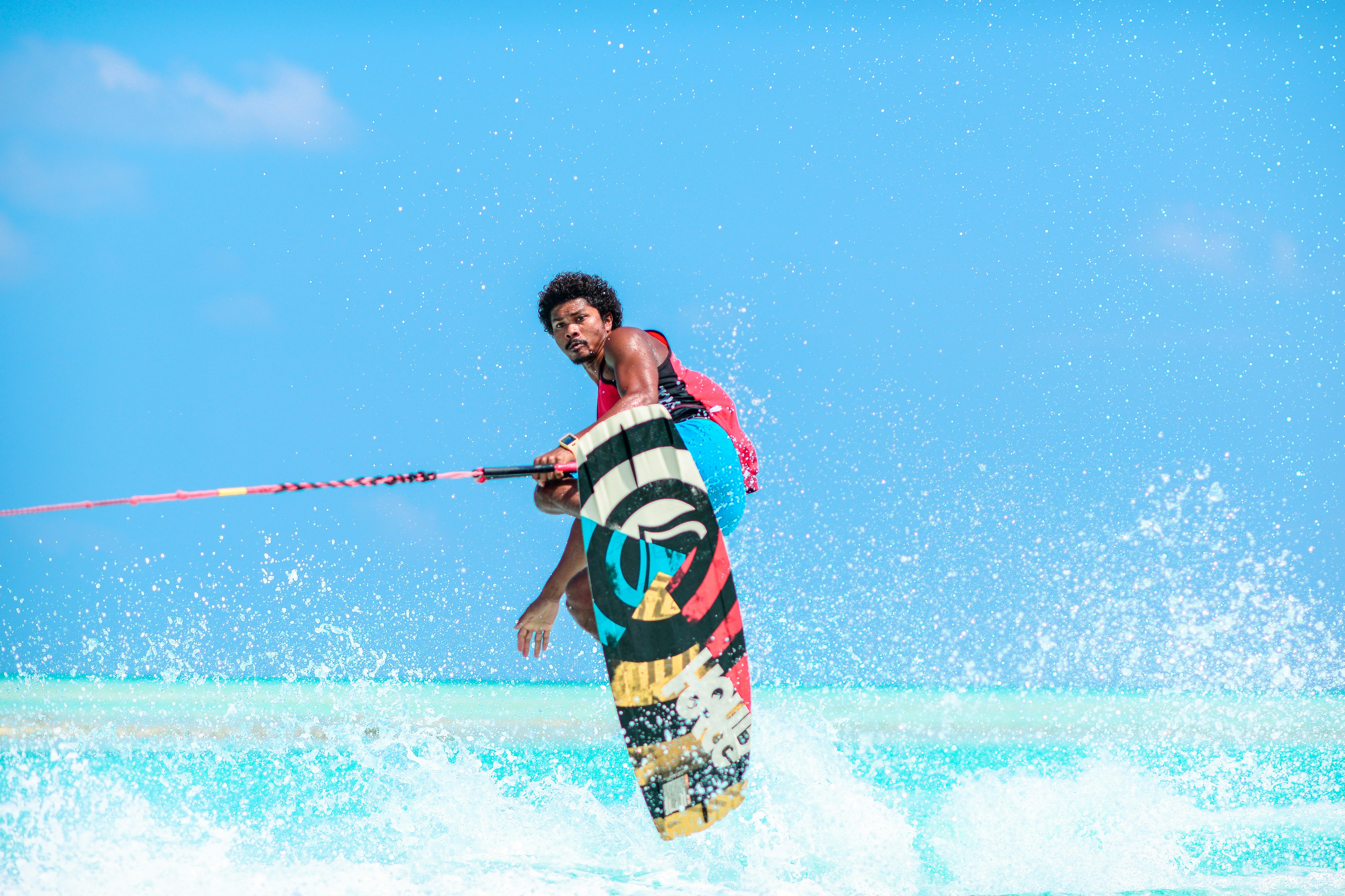man riding wakeboard during daytime