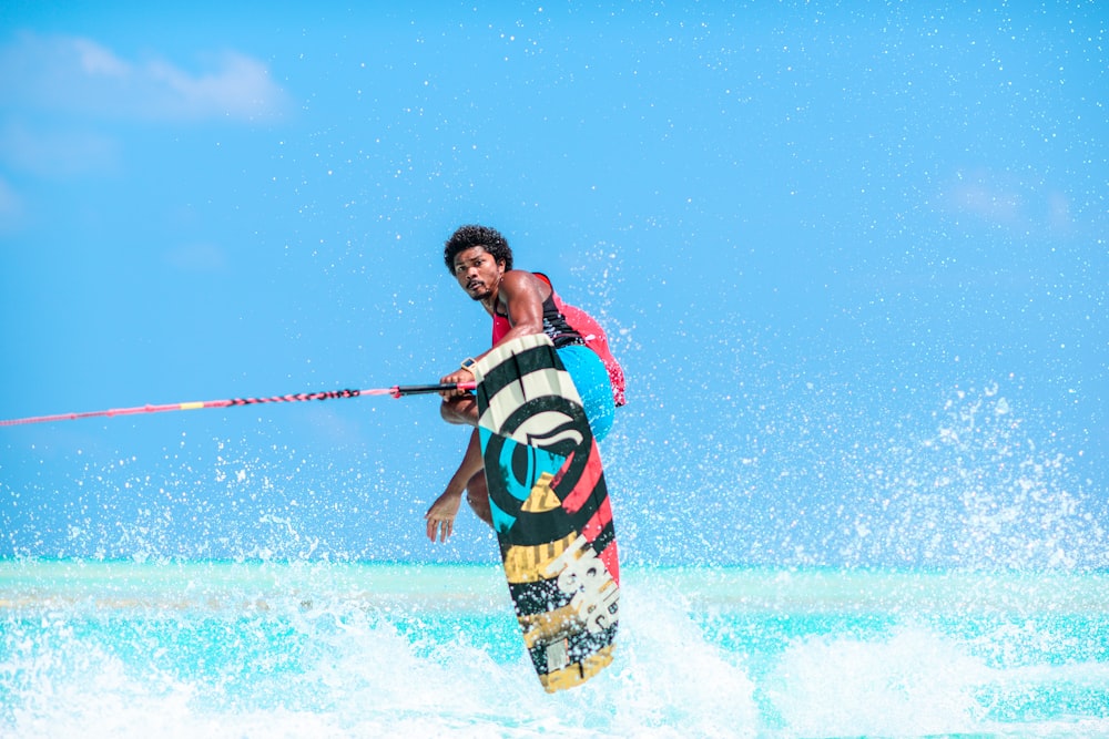 man riding wakeboard during daytime