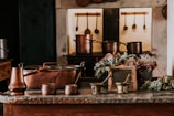 The rustic kitchen corner with traditional utensils and soft clay hues.