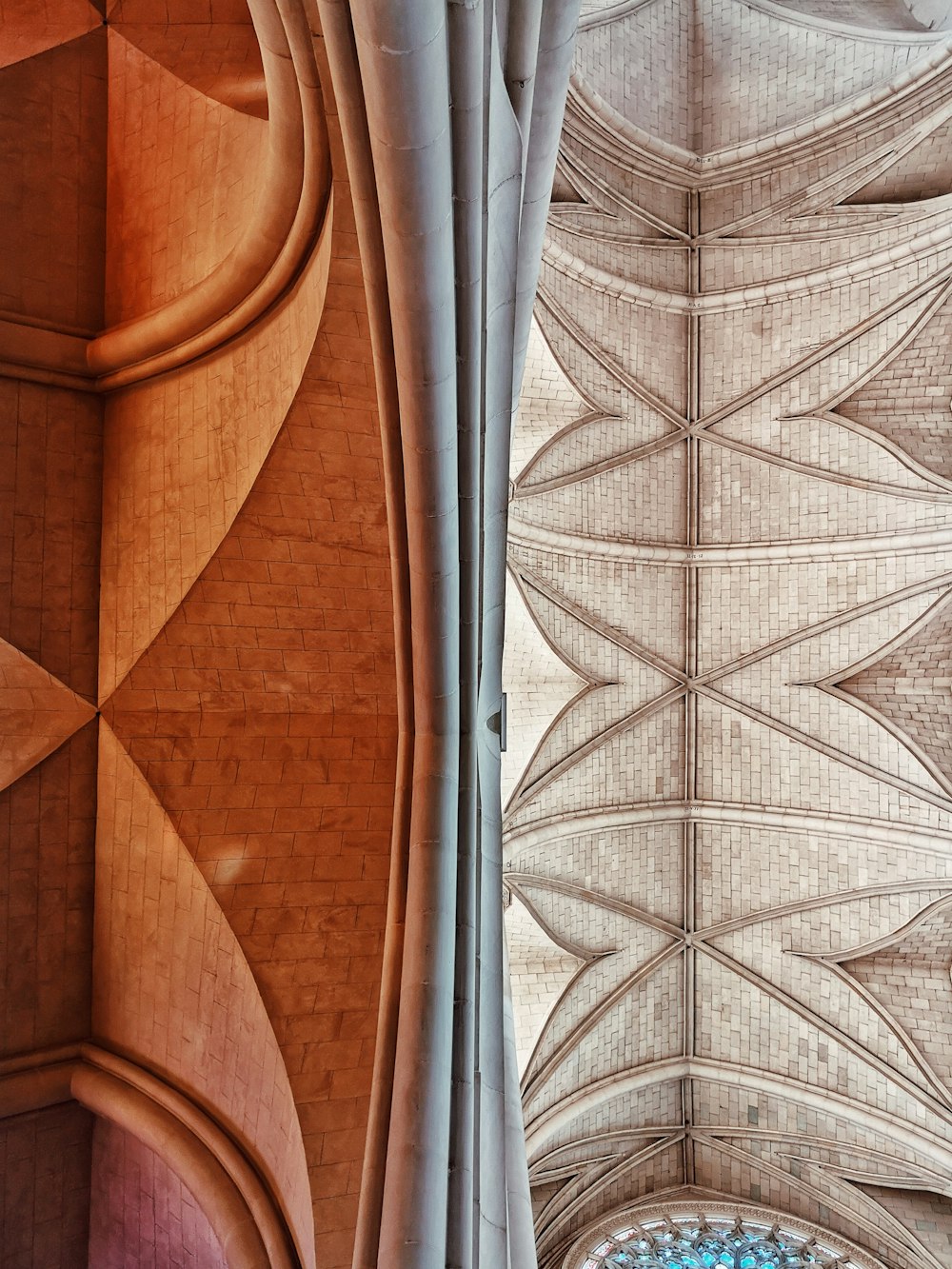 the ceiling of a large building with a clock on it