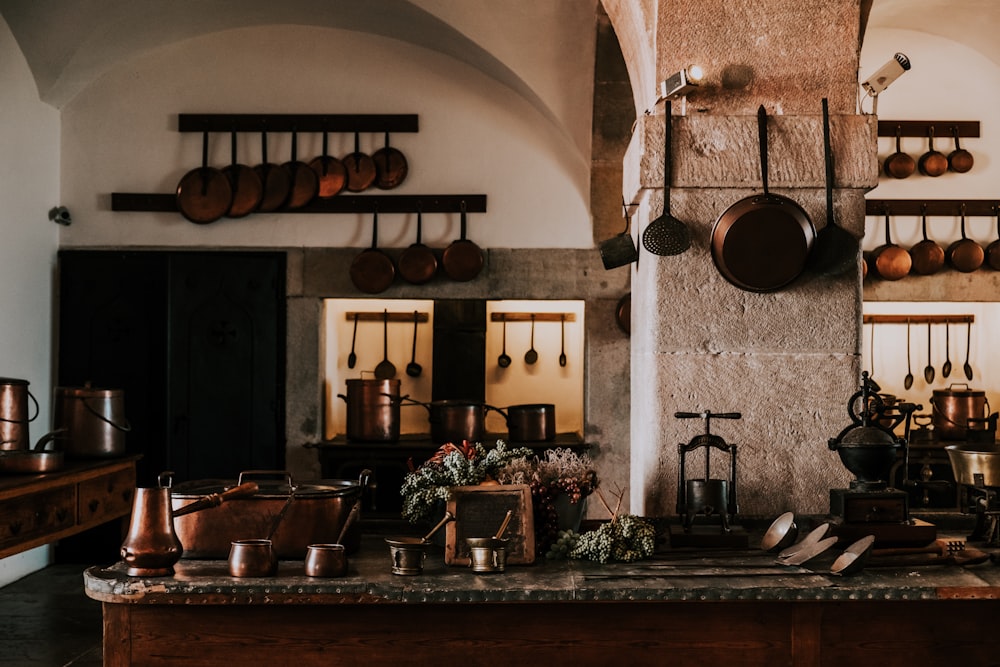 kitchen filled with cooking pans and kitchen utensils