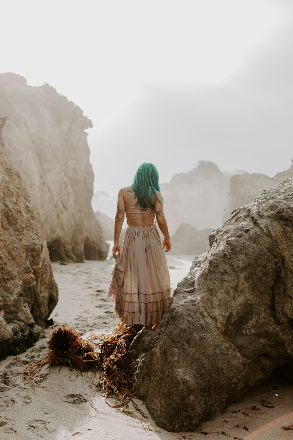 woman standing on rock formation