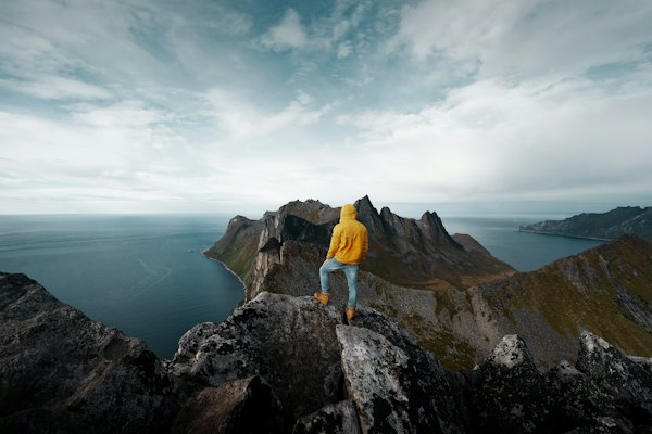 A hiker on the summit of Segla — Senja, Norway