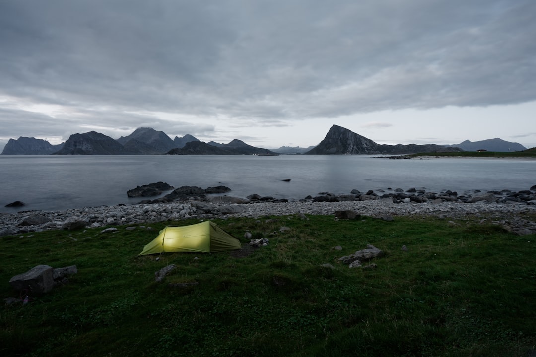 green cabin tent near sea