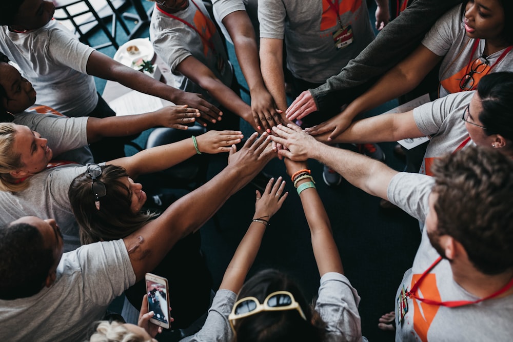 people with hands gathered in the middle