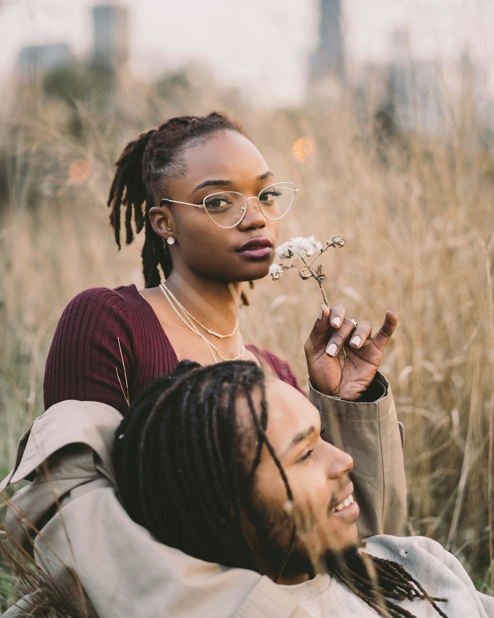 man leaning on woman's arm at the field during day