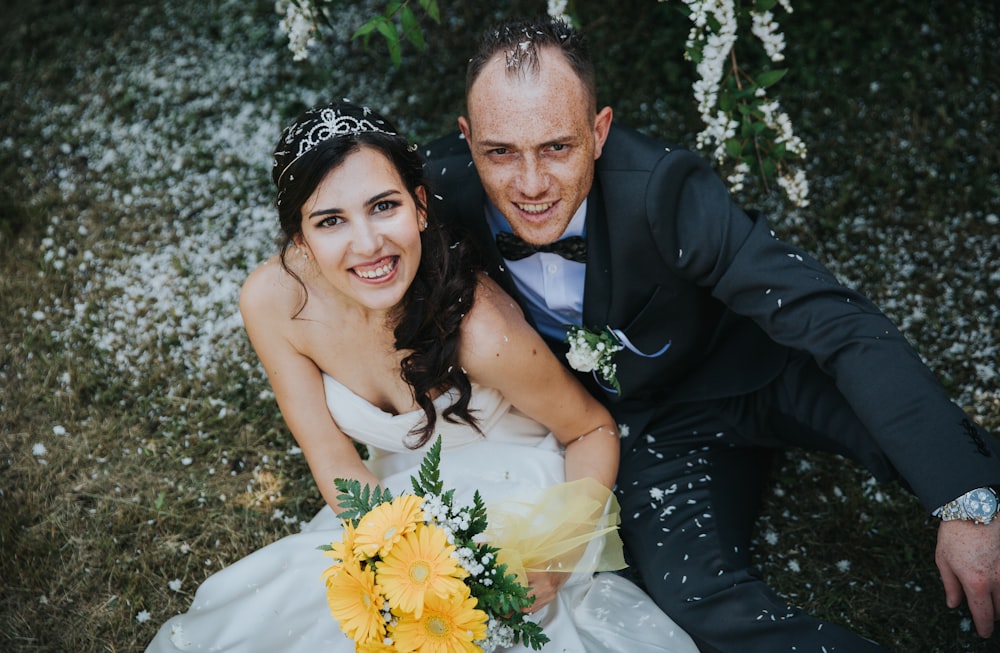 bride and groom sitting on ground