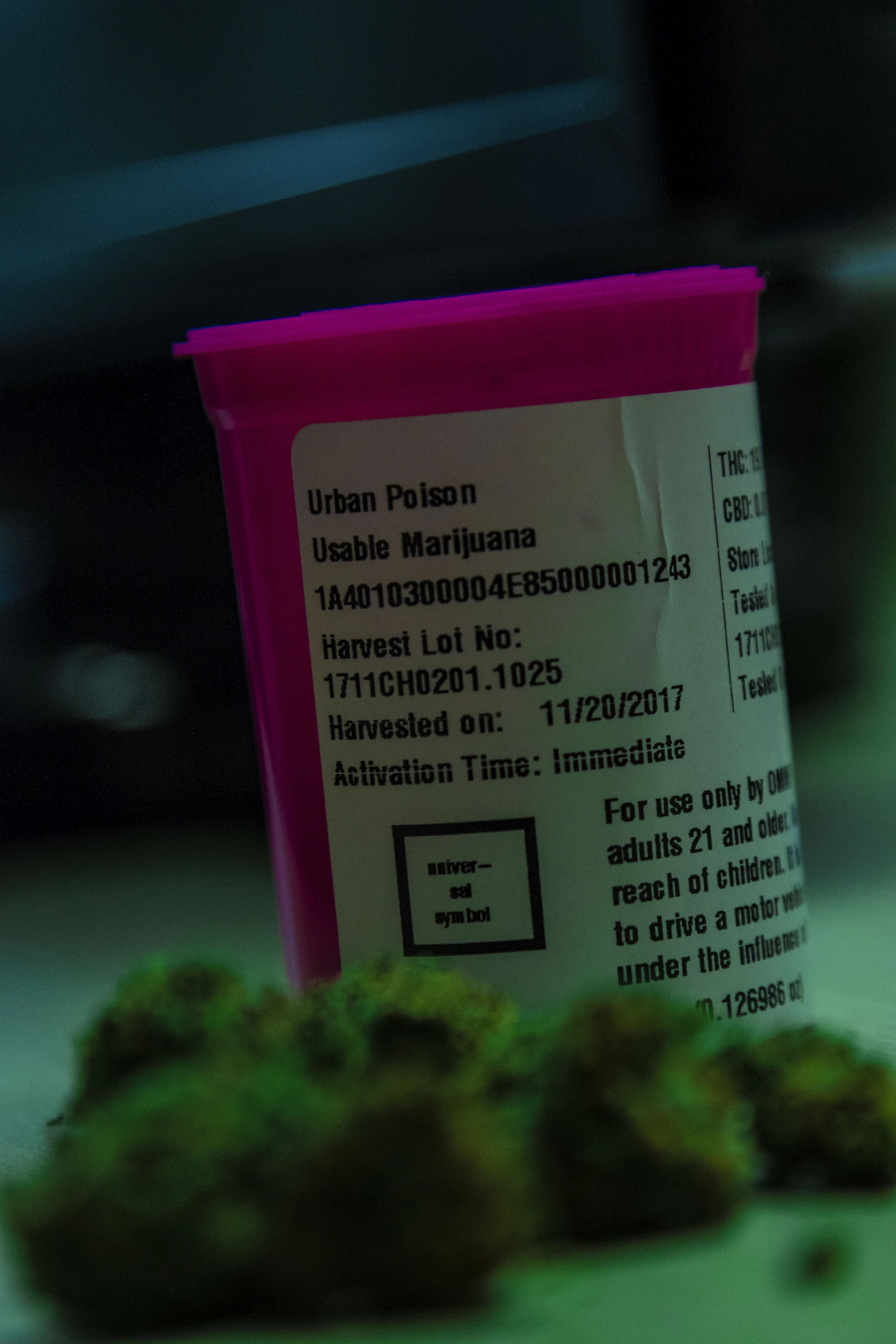 A compliance label on a cannabis container showing its package tag, harvest lot, and potency, the record state tracking follows