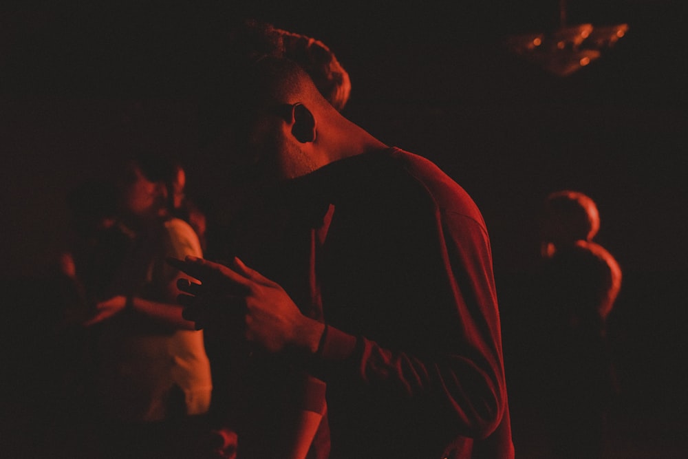 man wearing red crew-neck sweater