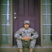 woman sitting in front of closed door