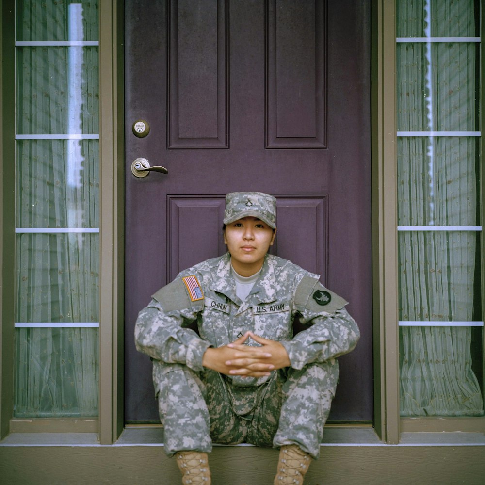 woman sitting in front of closed door